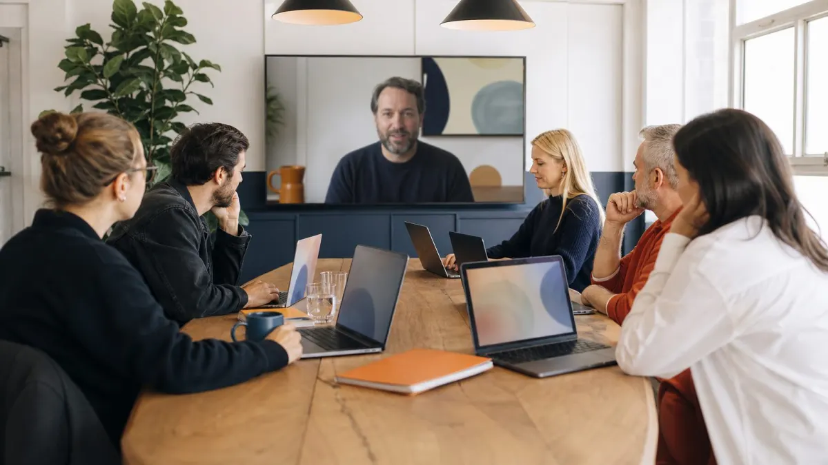 Rachel and two designers watch on a Zoom call as the consultant walks through the new brand voice GPT.